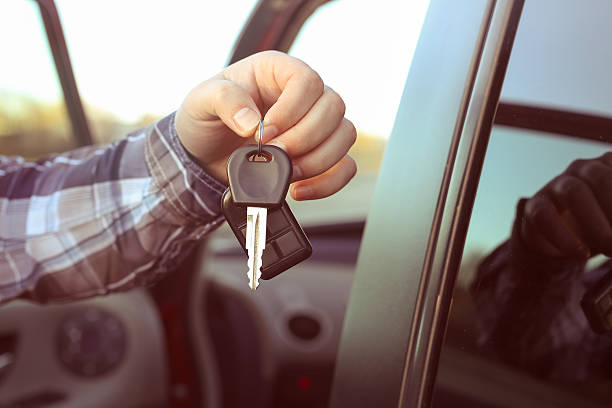 key in hand Men's hand in a checkered shirt holding a key from the car, symbolize joy purchase transport, crediting, driving Van Rentals stock pictures, royalty-free photos & images