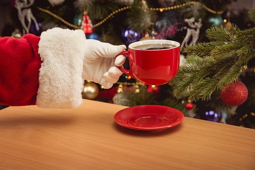 Santa Claus takes a cup of coffee