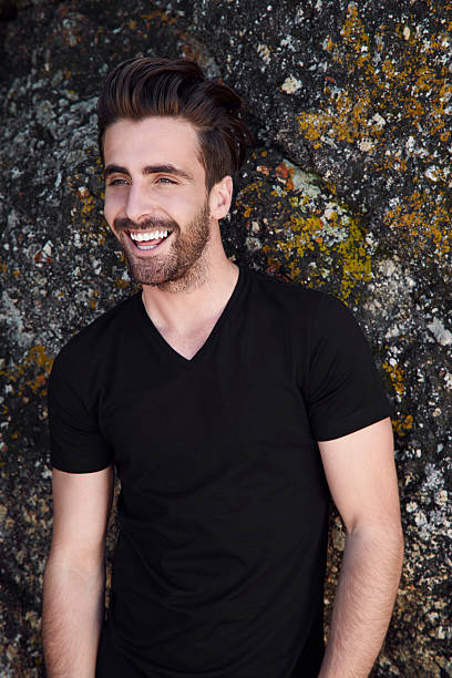 istock Laughing young man against rock 500186296