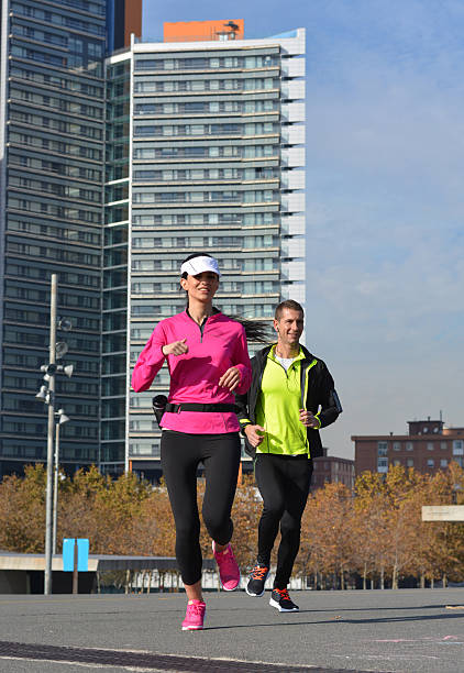 Young adult african athlete couple running outdoors. Blurred motion.