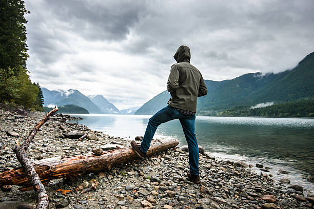 Solitude man pensive on the lake side Solitude man pensive on the lake side spirituality adventure searching tranquil scene stock pictures, royalty-free photos & images