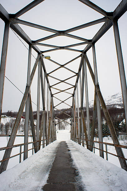 istock bridge on a frozen river in northern Norway 500188700