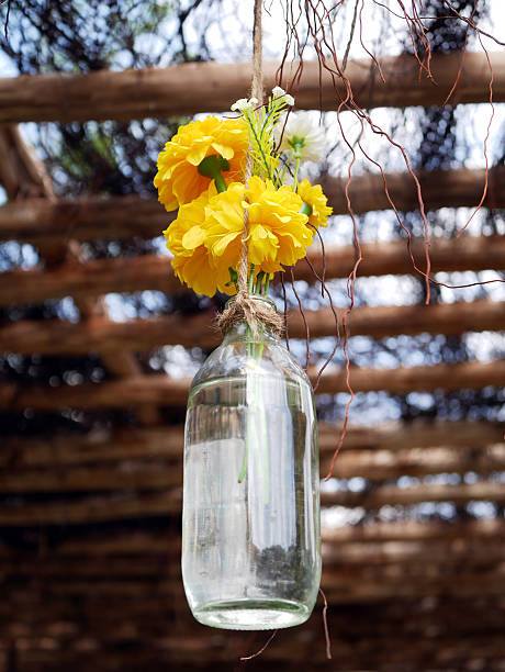 istock plastic yellow flower in grass bottle 500190066