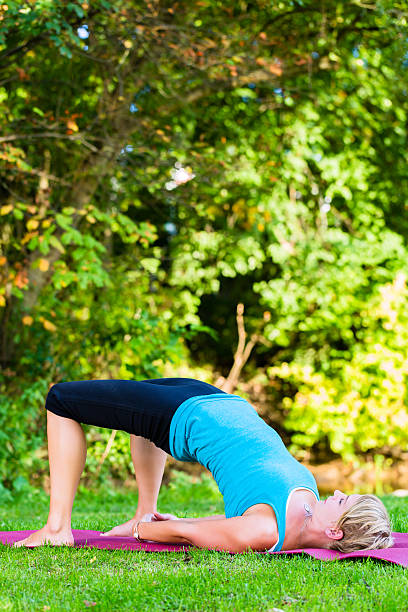 istock Young woman in nature doing yoga 500194335