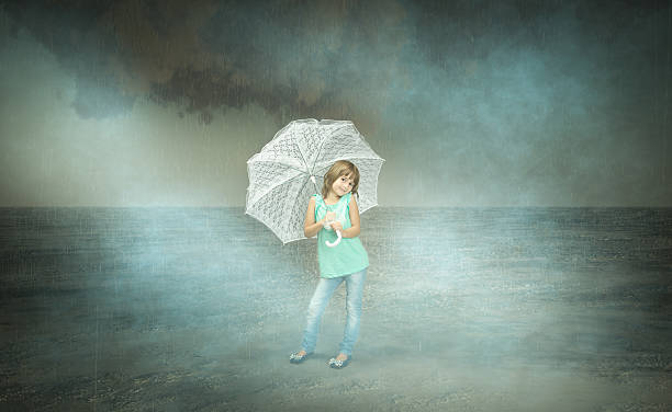 istock child under umbrella in a dark day 500194443