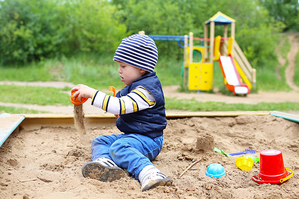 istock lovely 21 months baby playing with sand 500195797
