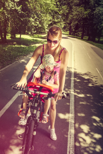 Mother and daughter are preparing for a ride together. Toned image. Real people, real mother and daughter.