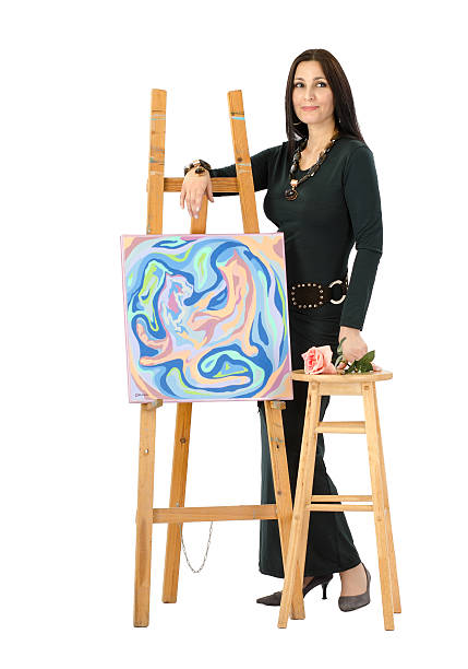 Artist leaning on an easel with abstract painting Cats