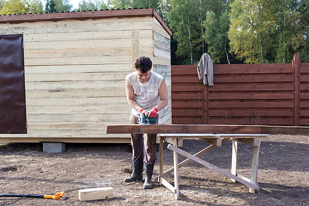 istock man cut wooden beam with circular saw 500197630