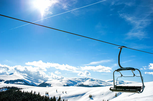 istock Mountain slopes with chairlift on a winter sunny day 500197785