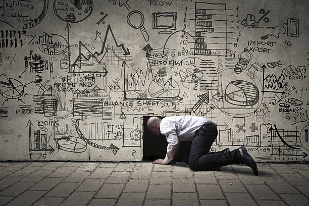 Business wonderland Businessman crawling into a small black hole, with illustrations on the wall escaping stock pictures, royalty-free photos & images