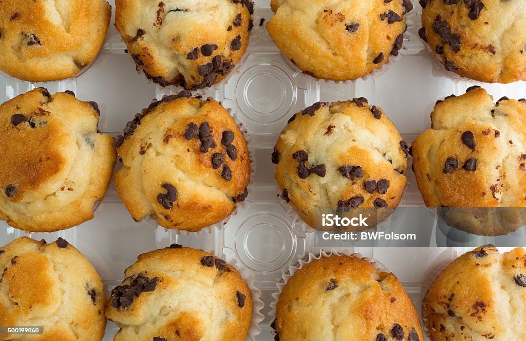 Group of chocolate chip muffins in container Top view of a group of freshly baked chocolate chip muffins in the plastic container. 2015 Stock Photo