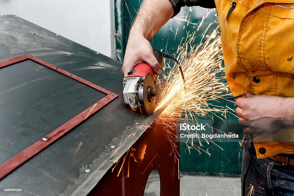 industrial worker cutting metal and grinding steel with tools Blue-collar Worker Stock Photo