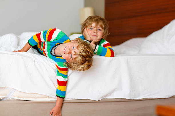 istock Two little sibling kid boys having fun in bed 500199582