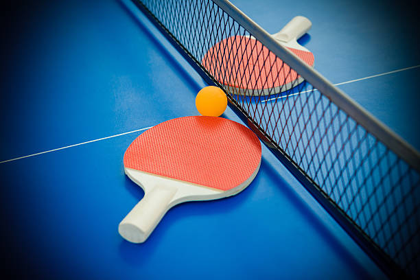 istock pingpong rackets and ball highlighted on a blue pingpong table 500200528