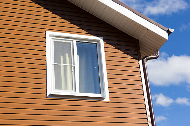 istock window in wall of brown vinyl siding 500200564