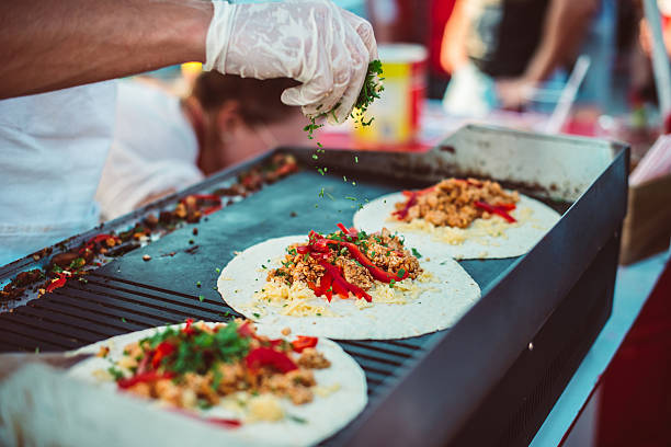 Fajitas Preparation of fajitas, mexican beef with grilled vegetable in tortilla wraps. Street food and outdoor cooking concept street food stock pictures, royalty-free photos & images