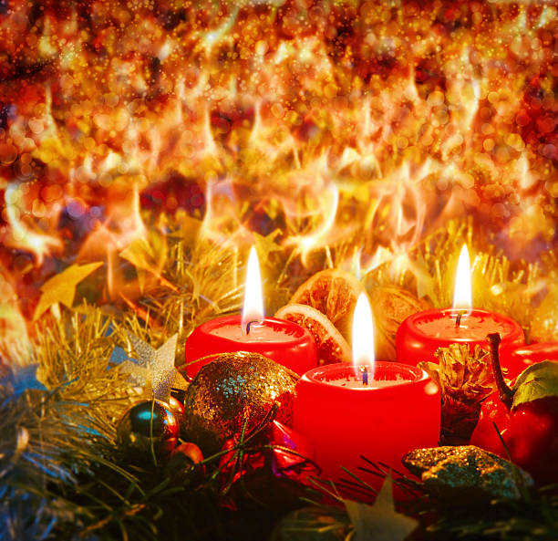 Advent candles with christmas decoration in atmospheric light.  Three red Advent candles .