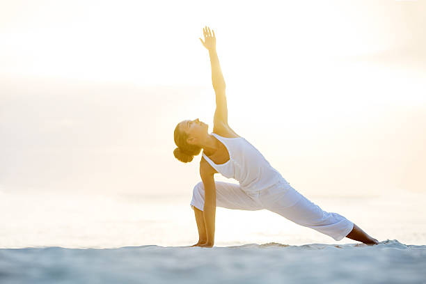 istock Caucasian woman practicing yoga at seashore 500202988