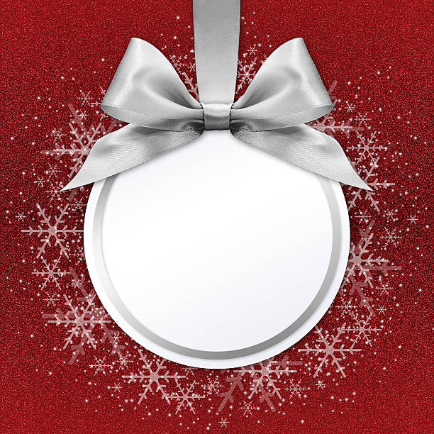 christmas ball with silver satin ribbon bow on red background