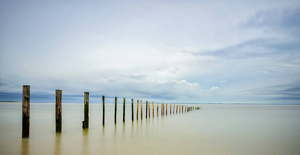 istock Poles at the beach before a storm 500210746