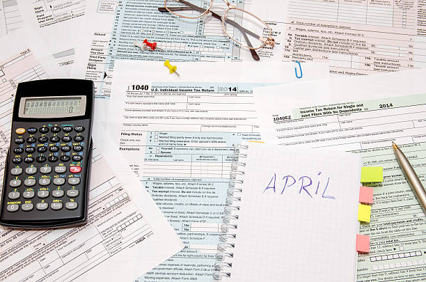 istock Tax forms with pen, calculator, glasses 500211684
