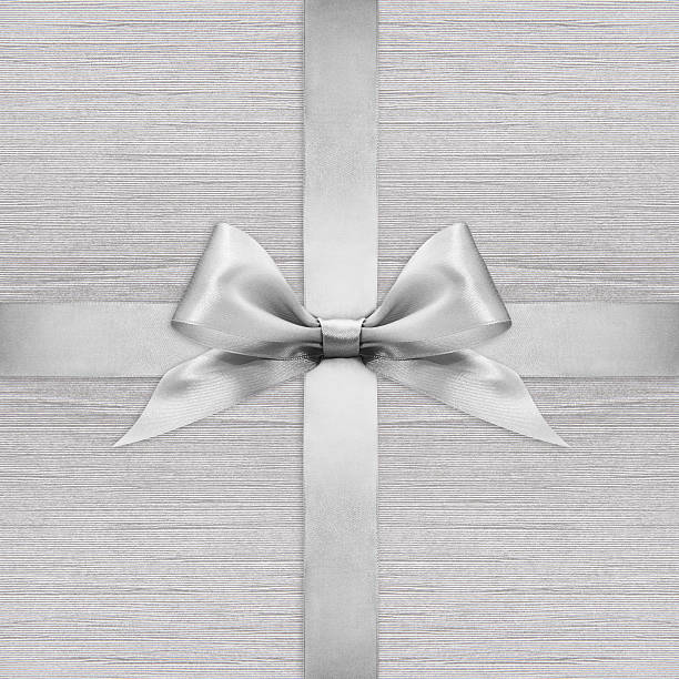 istock Shiny silver satin ribbon bow on argent background 500212914