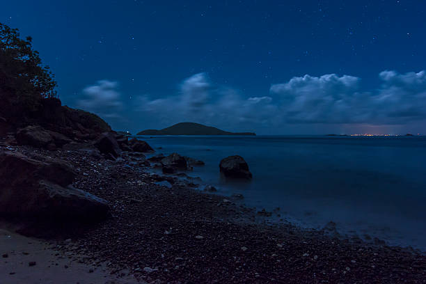 Caribbean island nights Distant lights of Vieques island in the Caribbean under layer of clouds and starry night sky seen from northwestern peninsula of Isla Culebra, Puerto Rico culebra island photos stock pictures, royalty-free photos & images