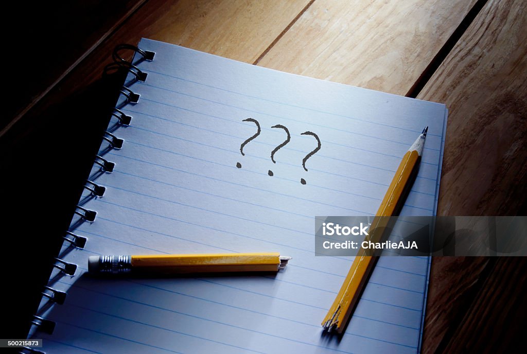 Writers block Three questions mark and broken pencil on top of a note pad Broken Stock Photo