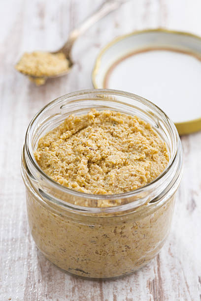 istock homemade mustard in a glass jar, top view 500216744