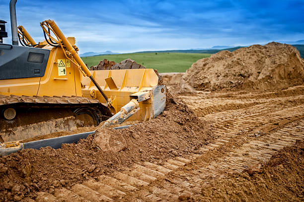 istock Heavy bulldozer and excavator loading  and moving red sand 500217169