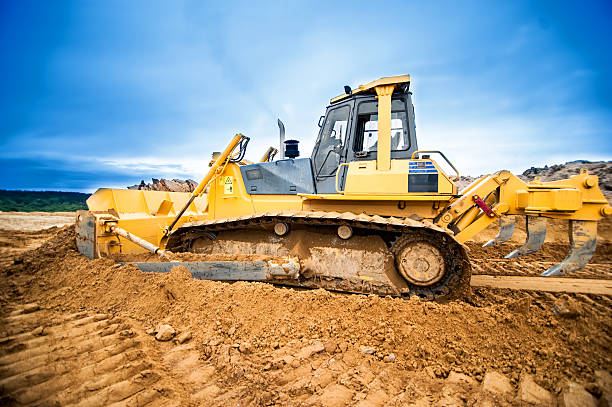istock Excavator working and moving earth in construction site, highway 500217363