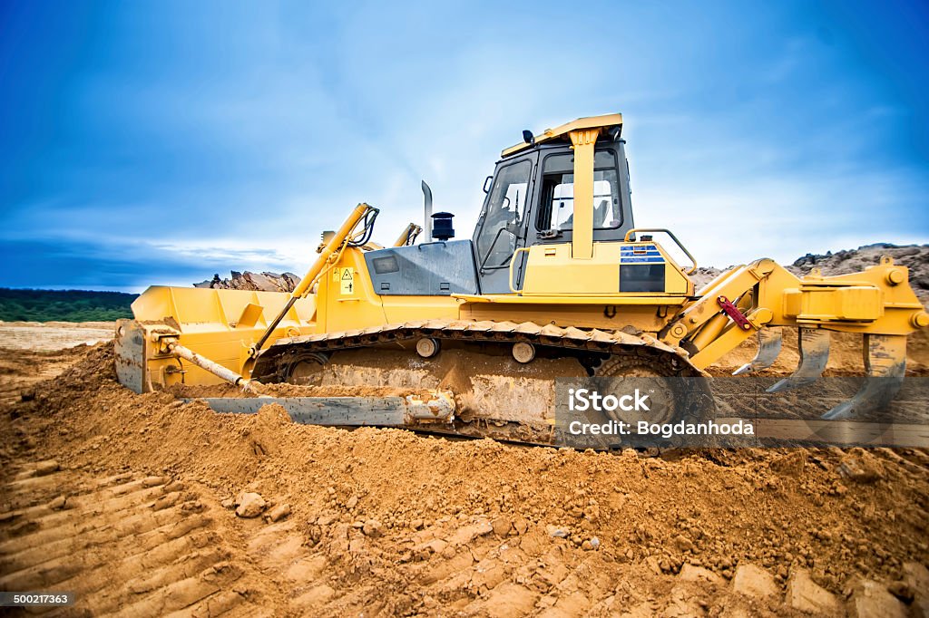 Excavator working and moving earth in construction site, highway Excavator working and moving earth in construction site, highway road in construction Accessibility Stock Photo