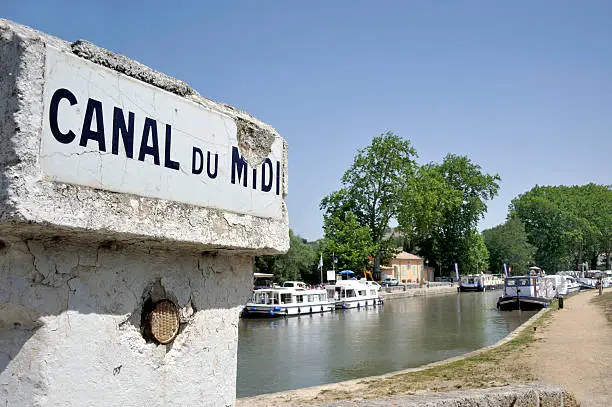 Southern France, Canal de Midi at the village of Capestang. Focused at the sign with the name of the canal.