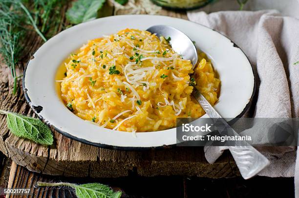 Carrot Risotto In The Plate On Wooden Table Stock Photo - Download Image Now - Arborio Rice, Backgrounds, Barley