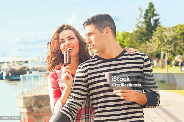 Happy Couple Eating Ice Cream Outdoors On A Sunny Day Stock Photo - Download Image Now