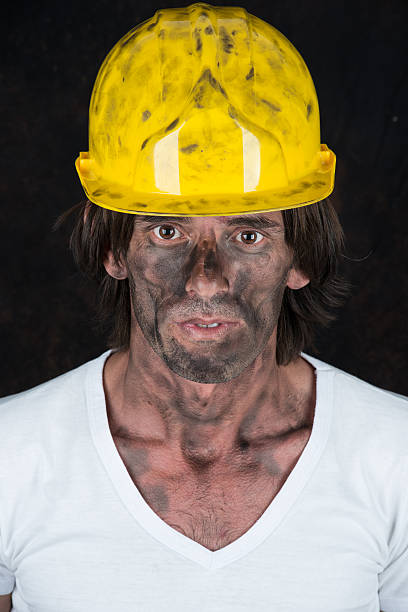 istock Dirty miner with hard hat close up face 500219107
