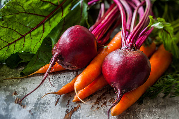 fresh carrot and beetroot Fresh organic carrots and beetroot  on old wooden board common beet photos stock pictures, royalty-free photos & images