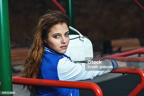 Fashionable Beautiful Girl Stands On Sports Ground Stock Photo - Download Image Now - 2015, Active Lifestyle, Activity