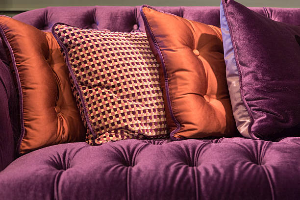 Close up of violet velvet sofa and cushions stock photo