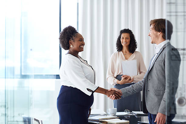 Welcome to the team! Shot of two businesspeople shaking hands in an officehttp://195.154.178.81/DATA/i_collage/pu/shoots/806073.jpg employee introduction stock pictures, royalty-free photos & images