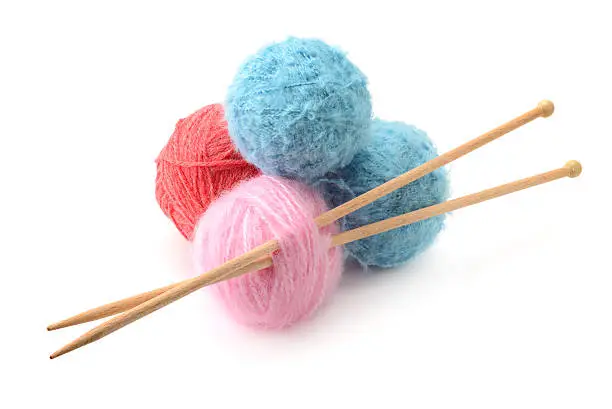 Woolen balls and knitting needles isolated on a white background