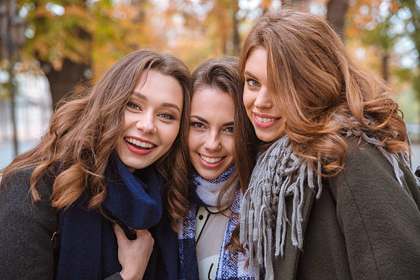 istock Smiling girlfriends standing in autumn park 500228062