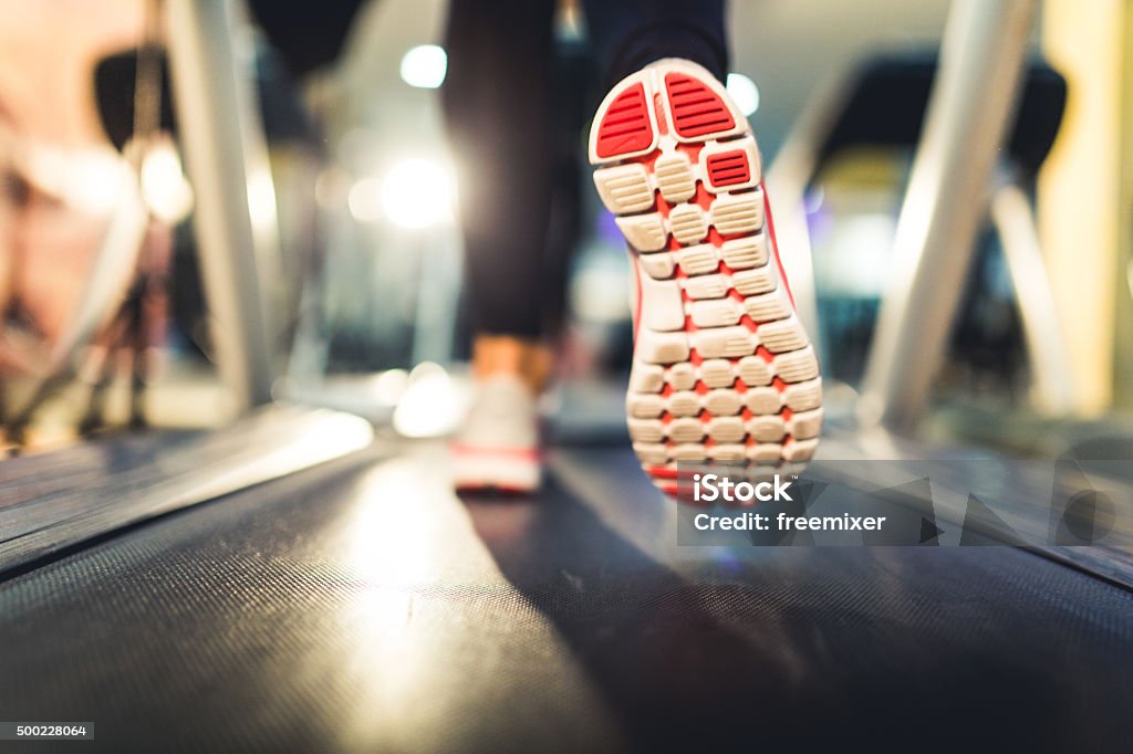 Close-up of Athlete shoes while running on treadmill Woman running on treadmill, close up on shoes Sports Shoe Stock Photo