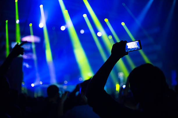 istock taking pictures  during a music concert 500228632