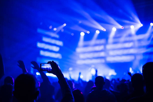istock taking pictures  during a music concert 500228646