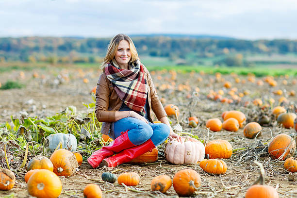 istock Beautiful woman working on pumpkin field 500230370