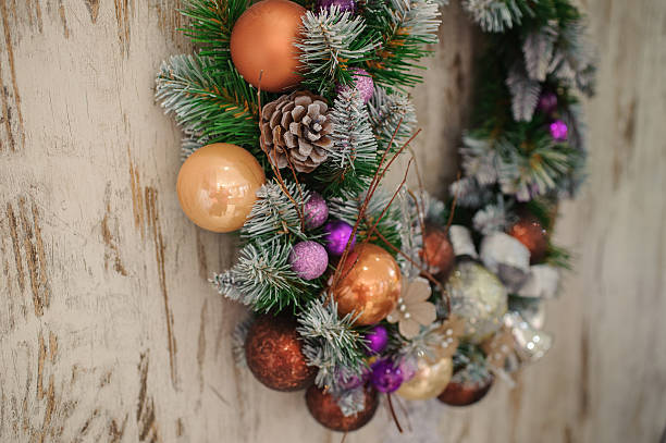 istock Green Christmas wreath with decorations on wooden background 500231954