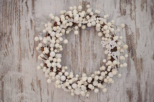 istock white christmas decorative wreath over wooden background 500232288