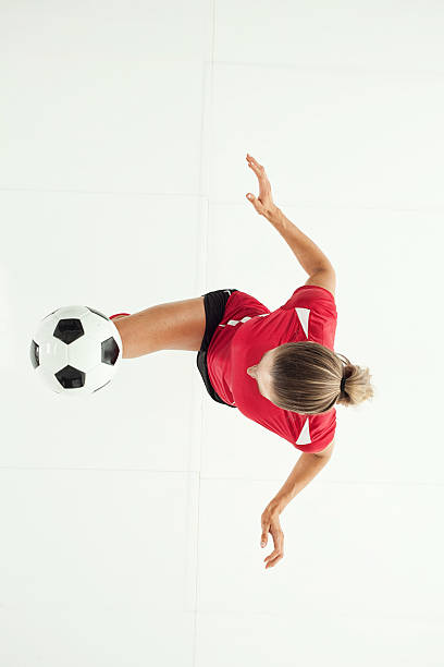 istock Female football player in action 500232808